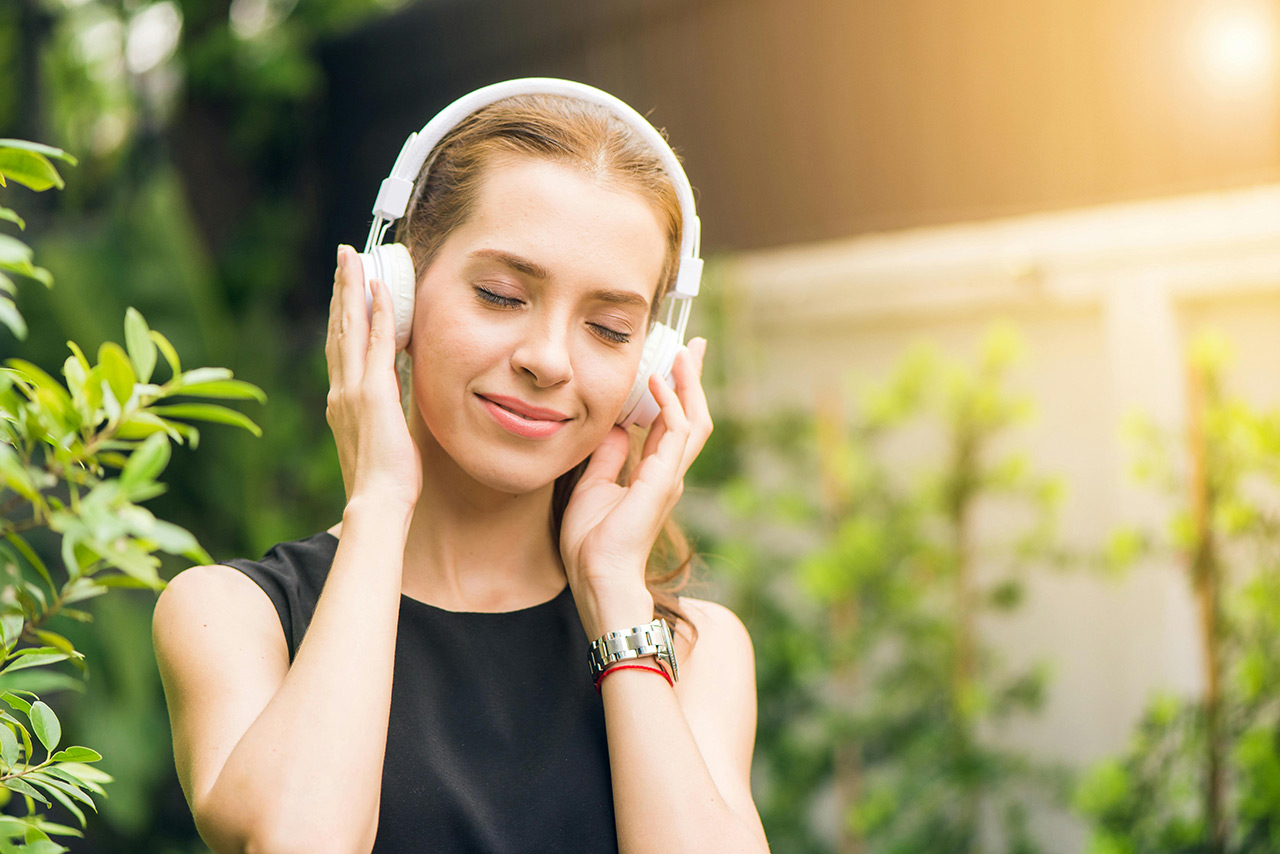 A relaxed woman wearing headphones